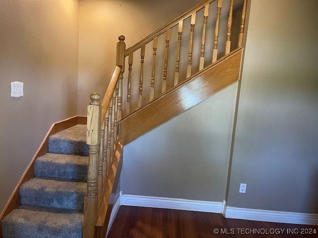 stairway with hardwood / wood-style flooring