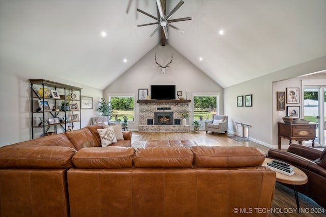 living room featuring ceiling fan, plenty of natural light, high vaulted ceiling, and hardwood / wood-style floors