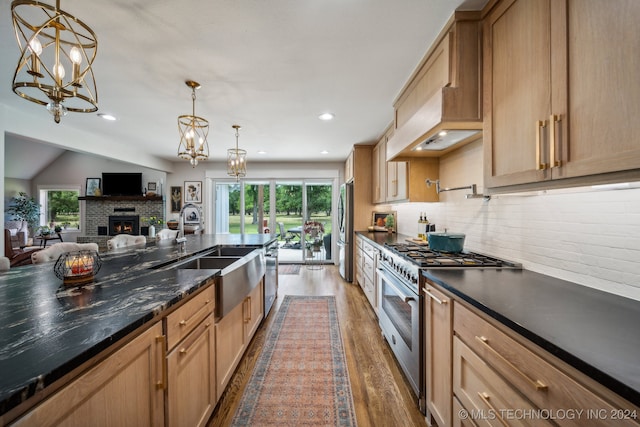 kitchen featuring decorative light fixtures, dark wood-type flooring, stainless steel appliances, and lofted ceiling