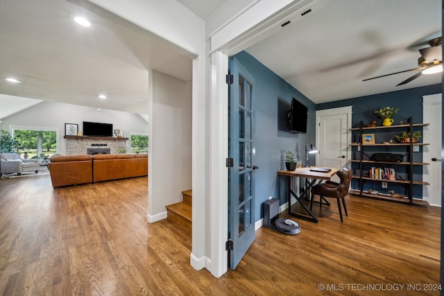 interior space with hardwood / wood-style flooring, vaulted ceiling, and ceiling fan