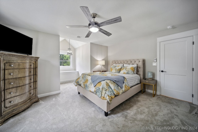 bedroom with ceiling fan, light carpet, and vaulted ceiling