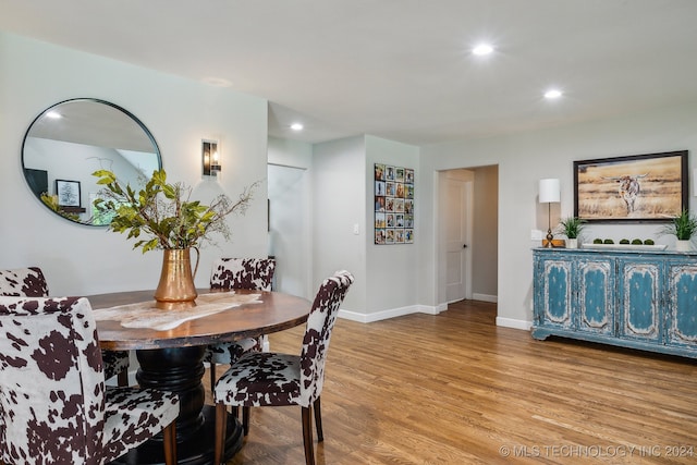 dining space with light hardwood / wood-style floors