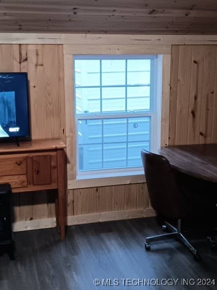 home office featuring dark hardwood / wood-style floors and wood walls