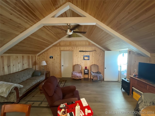 living room with ceiling fan, wooden ceiling, lofted ceiling with beams, wood walls, and hardwood / wood-style flooring