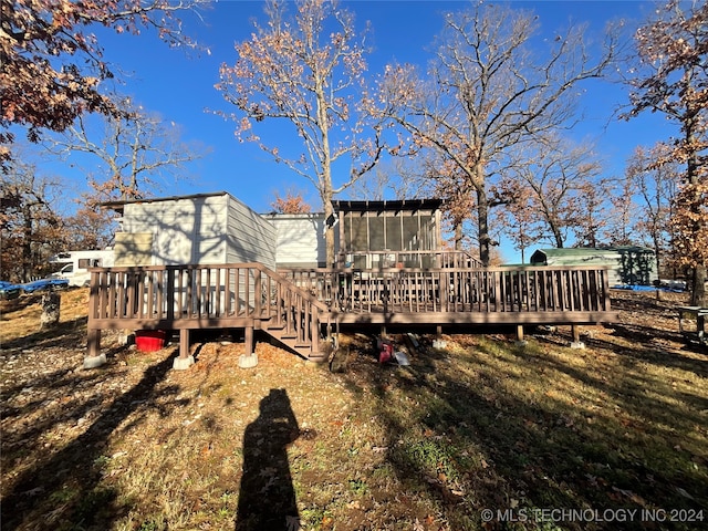 view of yard featuring a sunroom and a deck