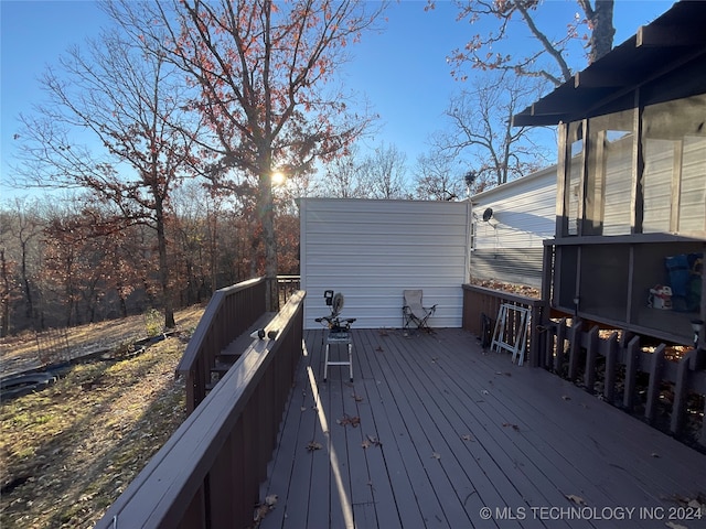 wooden deck with a sunroom