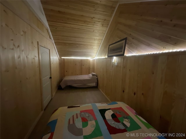 unfurnished bedroom with wood walls, wooden ceiling, and vaulted ceiling