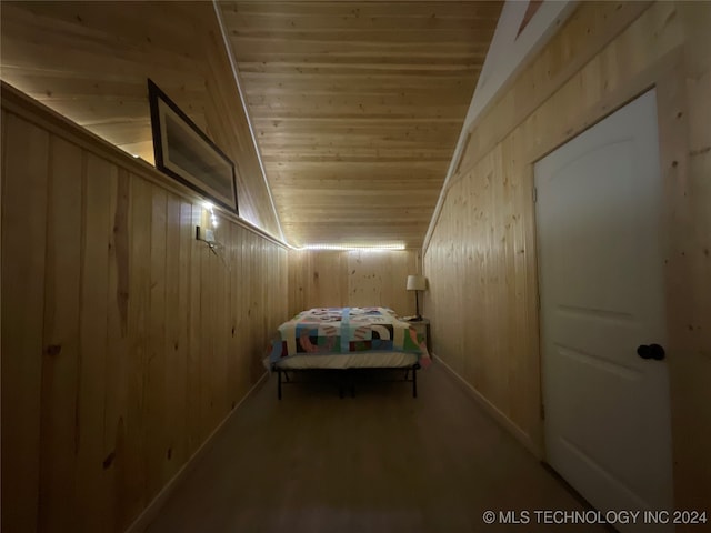 unfurnished bedroom featuring wood walls, lofted ceiling, and wood ceiling