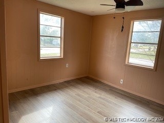 spare room with ceiling fan and light hardwood / wood-style flooring