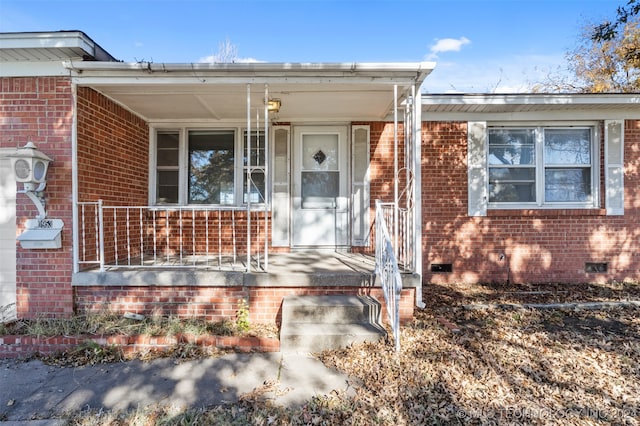 view of exterior entry with covered porch