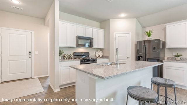 kitchen featuring sink, dark wood-type flooring, an island with sink, white cabinets, and black appliances