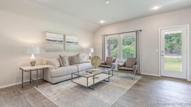 living room with hardwood / wood-style floors and vaulted ceiling