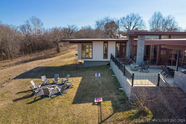 back of house with a lawn and a patio