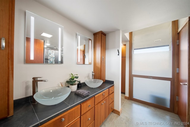 bathroom with tile patterned flooring and vanity