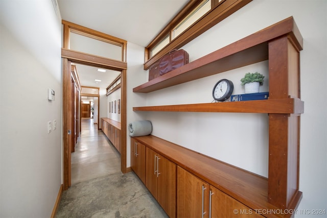 corridor featuring a healthy amount of sunlight and ornamental molding