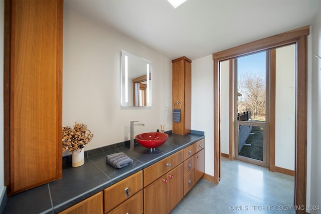 bathroom featuring vanity and concrete flooring