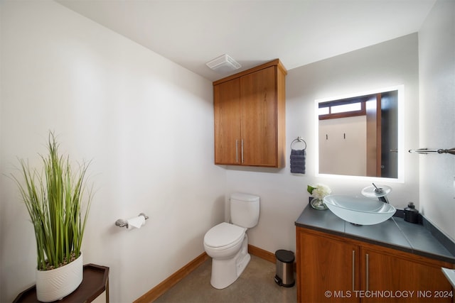 bathroom featuring vanity and toilet