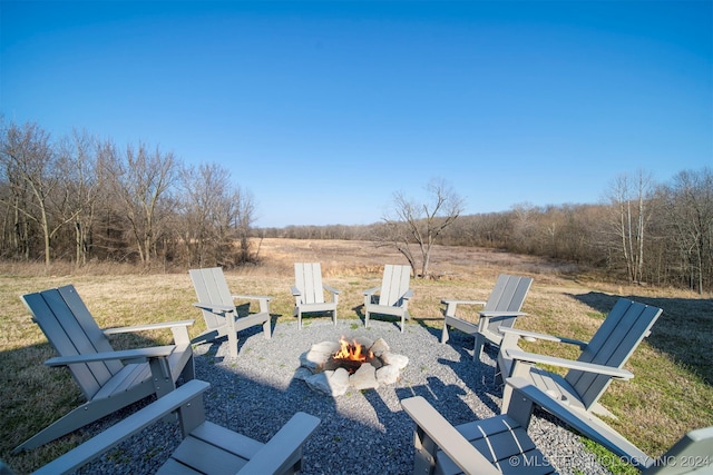 view of yard featuring a rural view and a fire pit