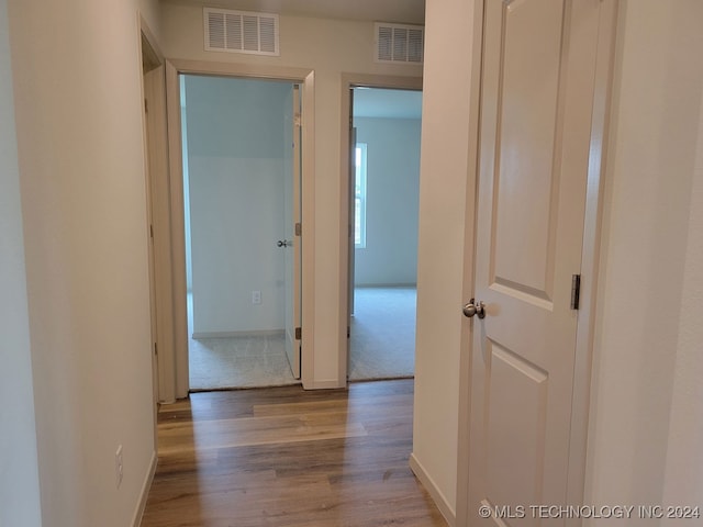 hall with light hardwood / wood-style floors