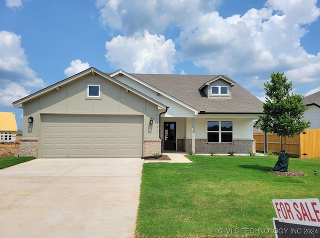 view of front of home with a garage and a front yard