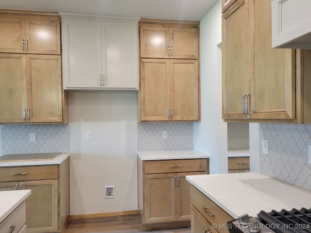 kitchen with hardwood / wood-style flooring and decorative backsplash