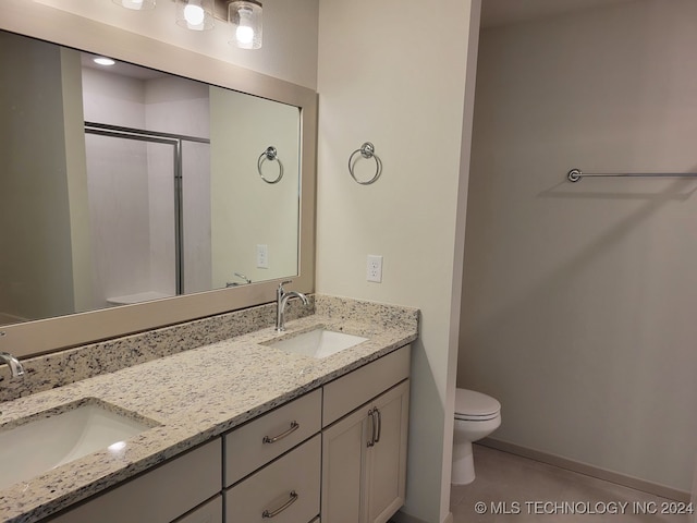 bathroom featuring tile patterned floors, toilet, an enclosed shower, and vanity