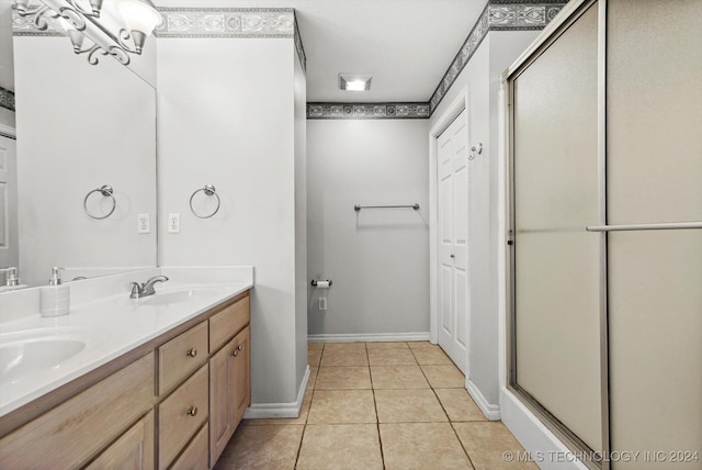 bathroom featuring tile patterned flooring, vanity, and an enclosed shower