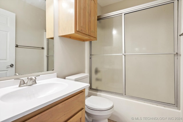 full bathroom with vanity, toilet, and bath / shower combo with glass door