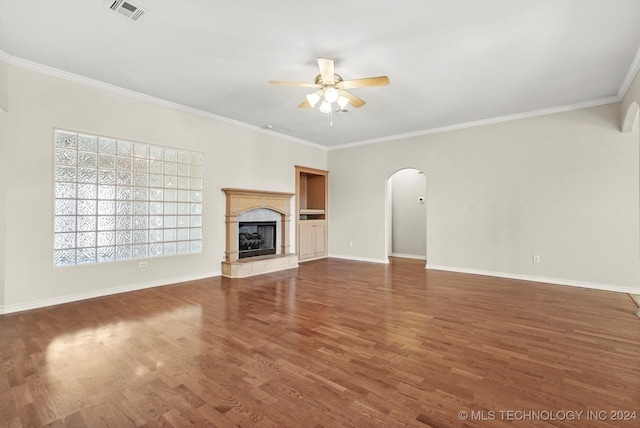 unfurnished living room with ceiling fan, dark hardwood / wood-style flooring, and ornamental molding