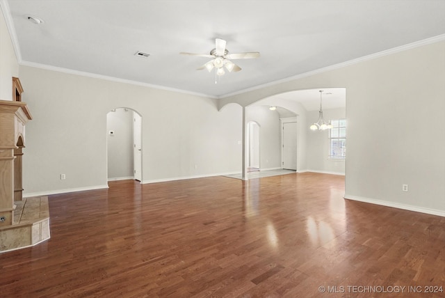 unfurnished living room with ornamental molding, ceiling fan with notable chandelier, dark wood-type flooring, and a tiled fireplace