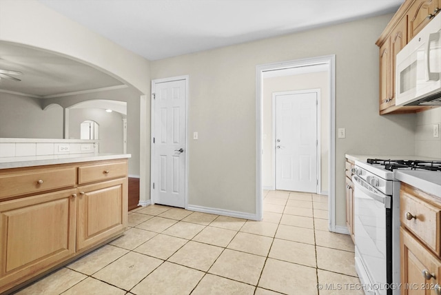 kitchen featuring ceiling fan, light tile patterned flooring, white appliances, and light brown cabinetry