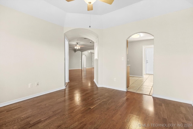 empty room featuring wood-type flooring and ceiling fan