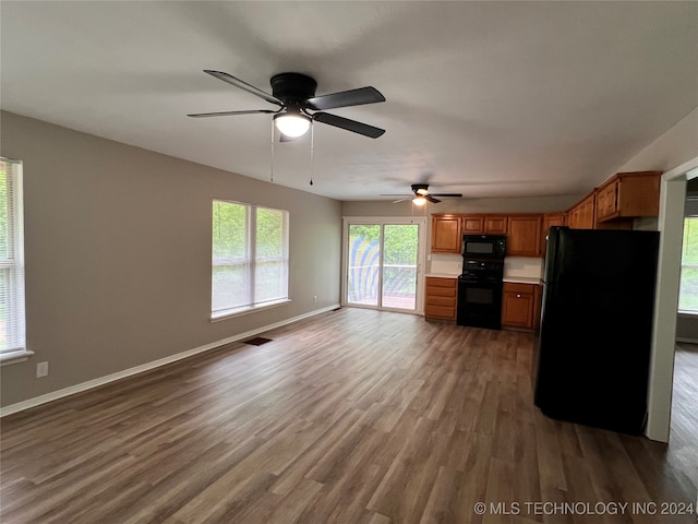 kitchen featuring ceiling fan, dark hardwood / wood-style flooring, and black appliances