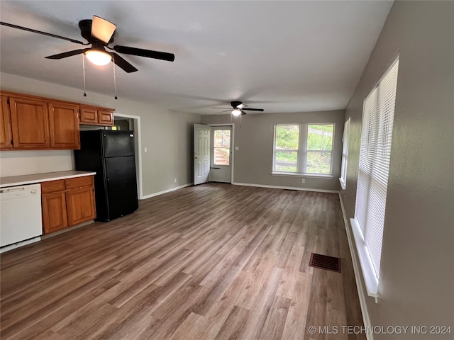 kitchen with ceiling fan, black refrigerator, white dishwasher, and light wood-type flooring