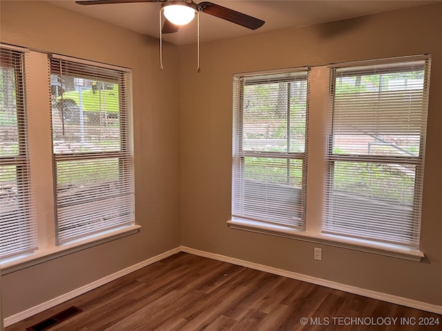 empty room featuring ceiling fan and dark hardwood / wood-style floors