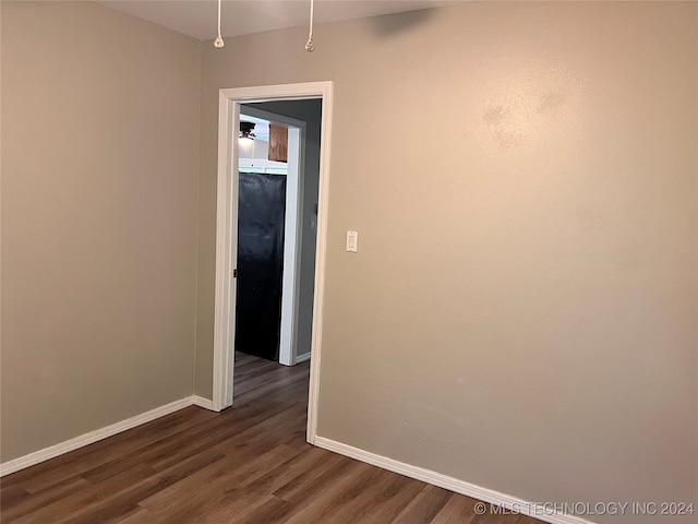 spare room with dark hardwood / wood-style floors