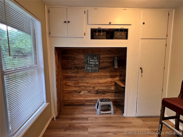 room details with hardwood / wood-style flooring and wood walls