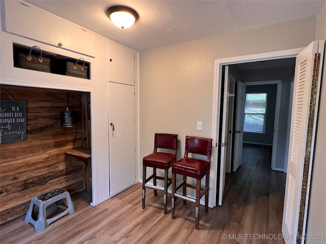 dining space featuring a textured ceiling and hardwood / wood-style flooring