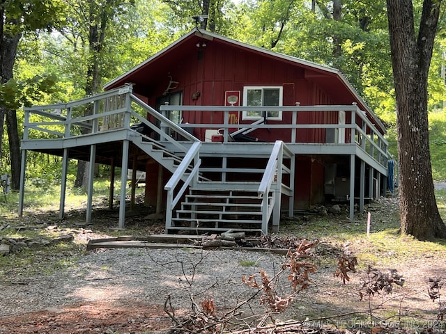 rear view of house featuring a deck