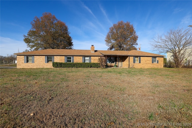 ranch-style home with a front lawn