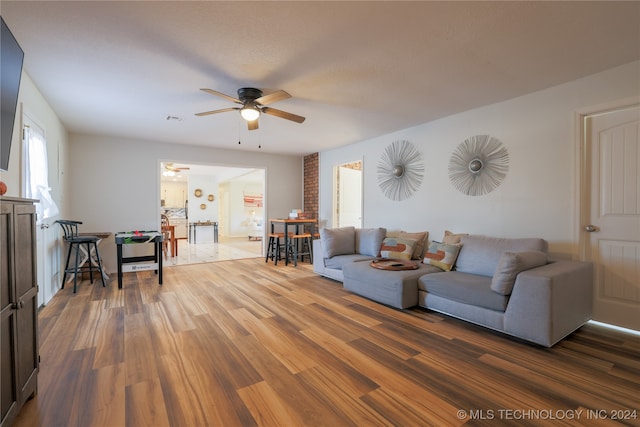 living room with ceiling fan and wood-type flooring