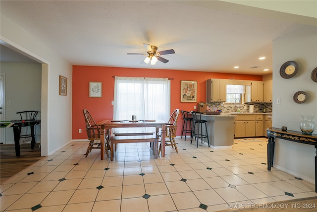 dining area featuring ceiling fan and sink