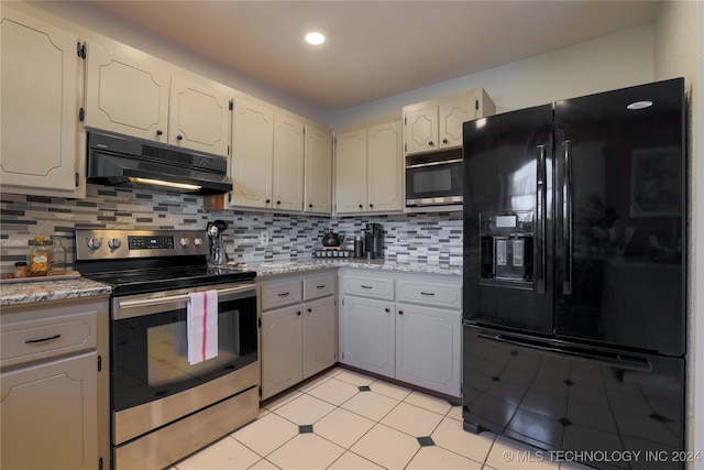 kitchen with backsplash, light stone counters, and stainless steel appliances