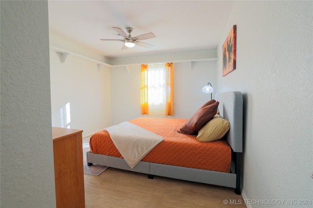 bedroom featuring hardwood / wood-style flooring and ceiling fan