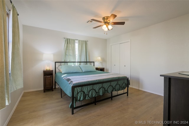 bedroom featuring hardwood / wood-style floors, a closet, and ceiling fan