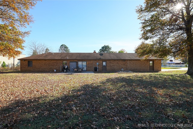 back of house featuring a patio area and a yard