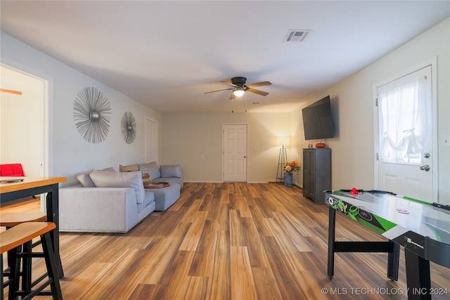 living room with ceiling fan and hardwood / wood-style flooring