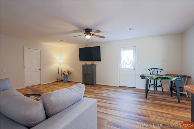 living room featuring ceiling fan and light hardwood / wood-style flooring