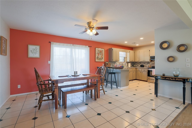 dining space with ceiling fan and light tile patterned flooring