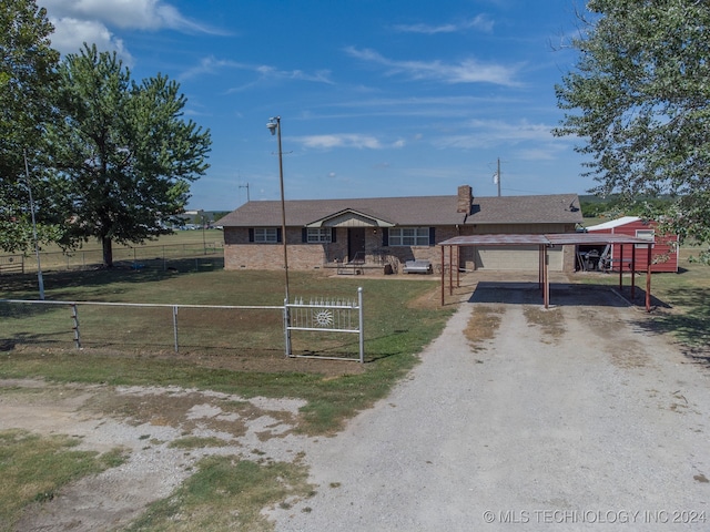 ranch-style house featuring a front lawn and a carport